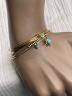 Semainier fin acier doré (7 bracelets), soleil et pierres